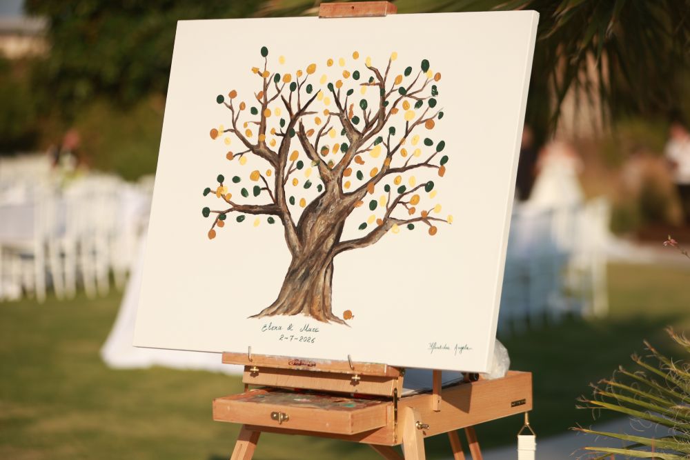 Wedding guests adding their fingerprints to a Wedding Tree canvas at Ktima 48, Anavyssos