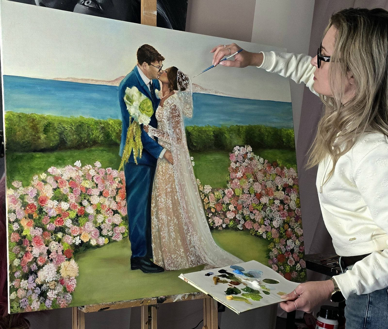 Wedding painting gift: finished large-scale live wedding painting of Giannis and Alexandria kissing by the sea among flowers, Island, Athens Riviera, by Angela Yfantidou