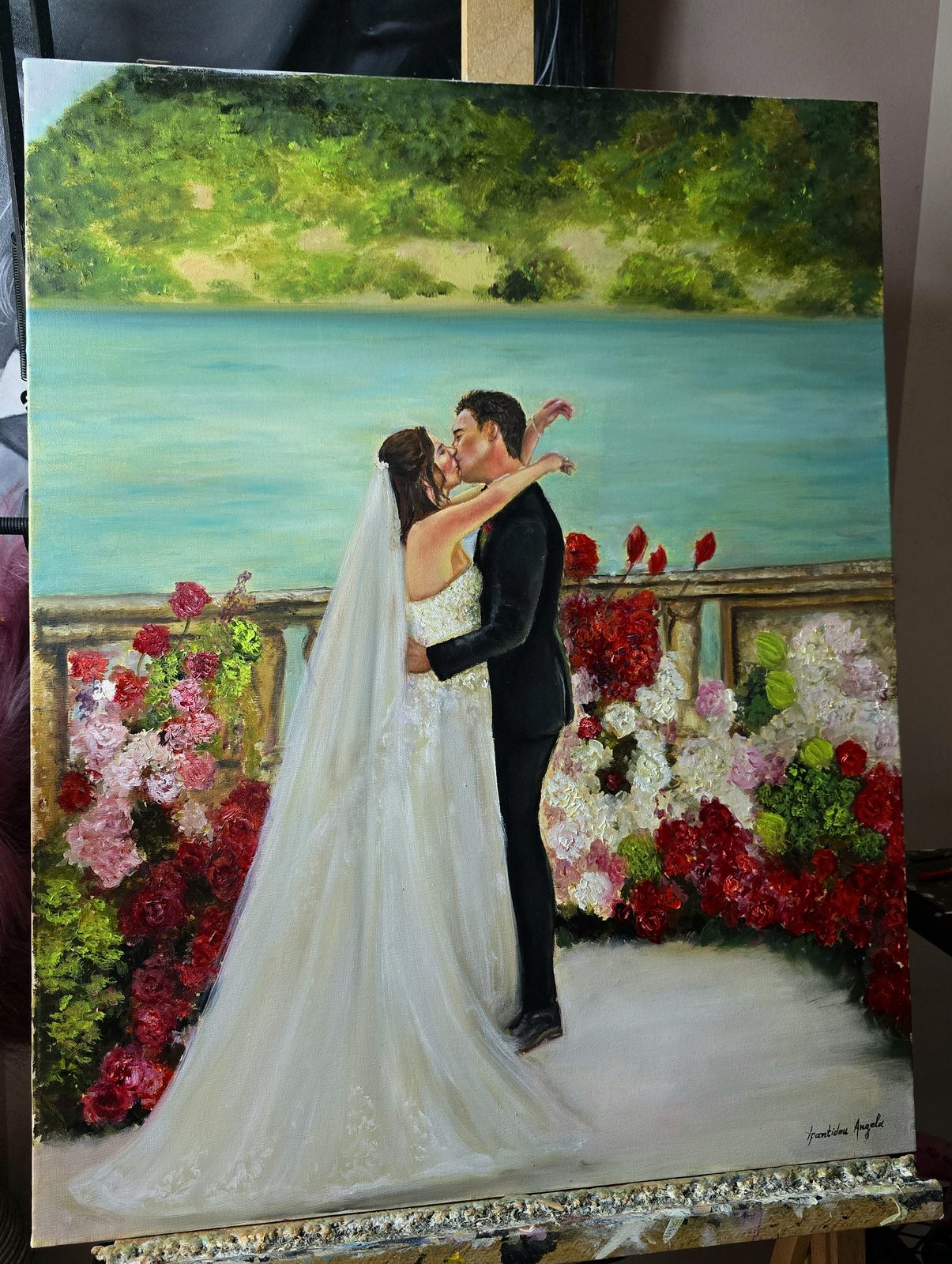 Finished realistic live wedding painting of Scott and Sydney kissing on the lakeside terrace of Villa Pizzo, Lake Como, by Lake Como wedding painter Angela Yfantidou